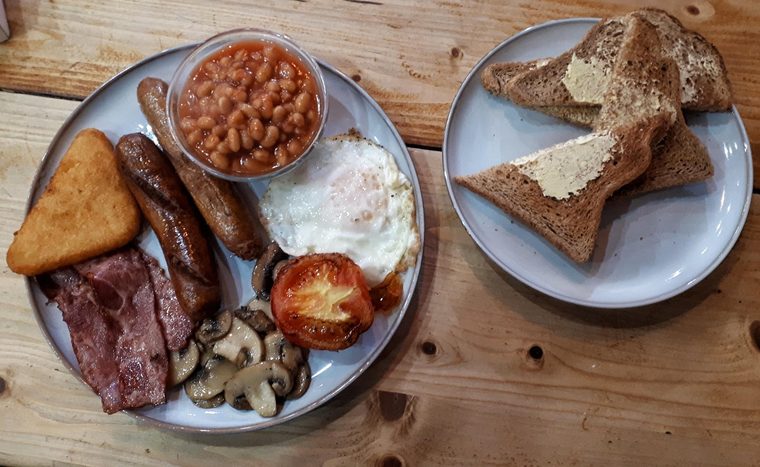 Full English breakfast with a side plate of buttered toast